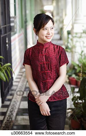 Close-up of a young woman standing in a corridor and smiling View Large Photo Image Picture - Close-up of a young woman standing in a corridor and smiling. Fotosearch