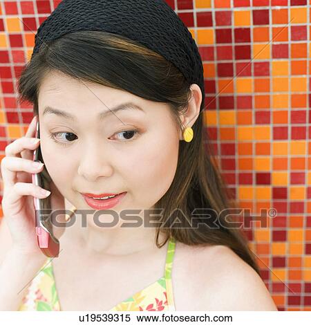 Stock Photography - Close-up of a young woman talking on a mobile phone. Fotosearch