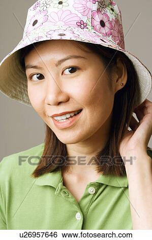 Stock Photograph - Close-up of a young woman wearing a hat. Fotosearch