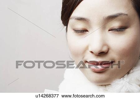 Close-up of a young woman with her eyes closed View Large Photo Image Stock Photo - Close-up of a young woman with her eyes closed. Fotosearch