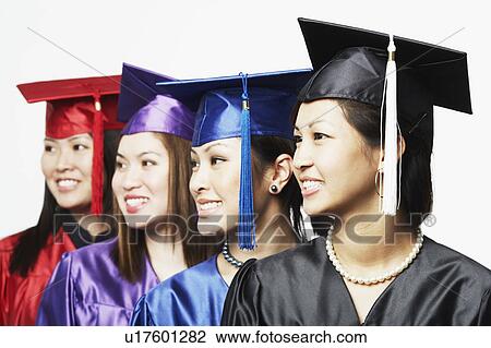 Close-up of four female graduates standing in a row View Large Photo Image Stock Image - Close-up of four female graduates standing in a row. Fotosearch