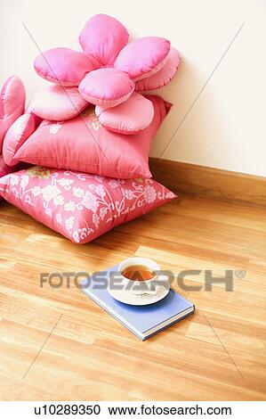 Stock Image - Close-up of pillows on a wooden floor. Fotosearch