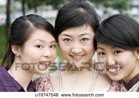 Stock Photo - Close-up of three young women smiling. Fotosearch