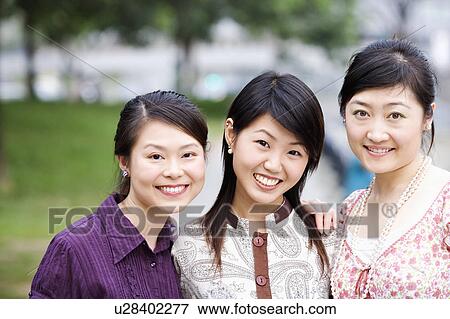 Stock Photo - Close-up of three young women smiling. Fotosearch