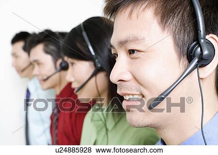 Four customer service representatives talking on headsets View Large Photo Image Stock Photo - Four customer service representatives talking on headsets. Fotosearch
