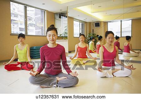 Four young women sitting in the lotus position View Large Photo Image Stock Image - Four young women sitting in the lotus position. Fotosearch