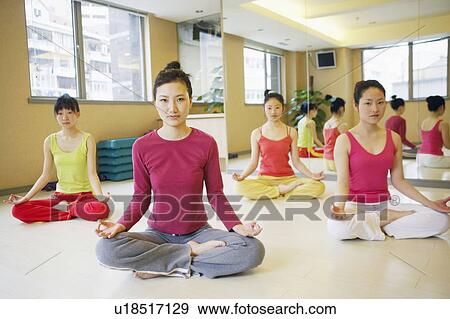Stock Photo - Four young women sitting in the lotus position. Fotosearch