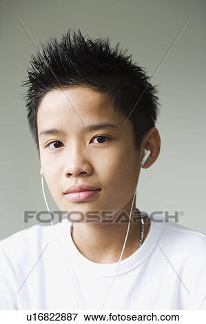 Stock Photo - Portrait of a boy listening to headphones. Fotosearch