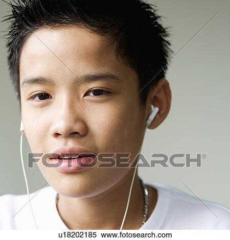 Stock Photography - Portrait of a boy listening to headphones. Fotosearch