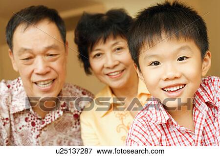 Stock Photo - Portrait of a boy with his grandparents. Fotosearch