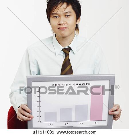 Portrait of a businessman sitting on a chair and holding a progress report View Large Photo Image Stock Photography - Portrait of a businessman sitting on a chair and holding a progress report. Fotosearch