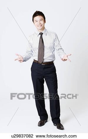 Portrait of a businessman smiling and gesturing View Large Photo Image Stock Image - Portrait of a businessman smiling and gesturing. Fotosearch