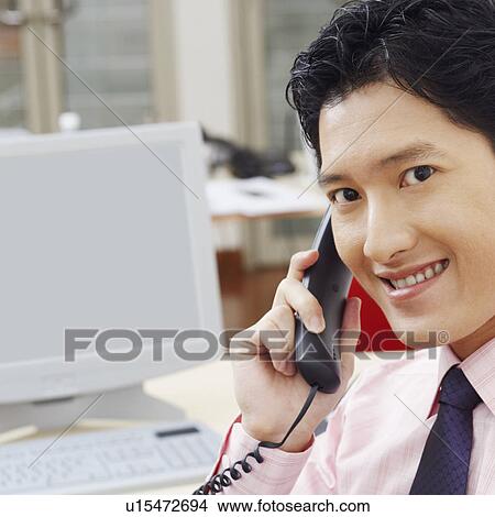 Portrait of a businessman talking on the telephone and smiling View Large Photo Image Picture - Portrait of a businessman talking on the telephone and smiling. Fotosearch