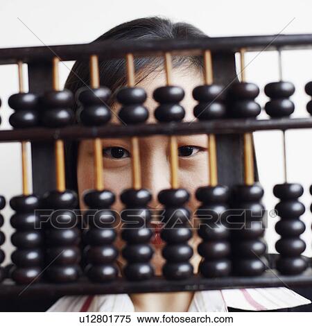 Stock Photography - Portrait of a businesswoman holding an abacus and smiling. Fotosearch