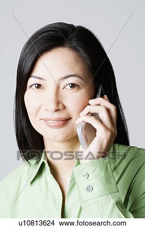 Portrait of a businesswoman talking on a mobile phone View Large Photo Image Picture - Portrait of a businesswoman talking on a mobile phone. Fotosearch