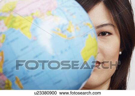 Portrait of a businesswoman with a globe in front of her View Large Photo Image Stock Image - Portrait of a businesswoman with a globe in front of her. Fotosearch