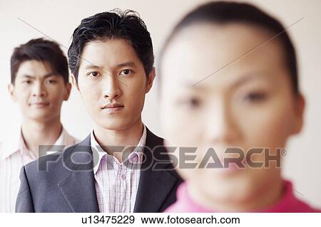 Portrait of a businesswoman with two businessmen in the background View Large Photo Image Stock Photo - Portrait of a businesswoman with two businessmen in the background. Fotosearch