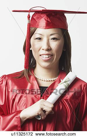 Stock Image - Portrait of a female graduate holding a diploma. Fotosearch