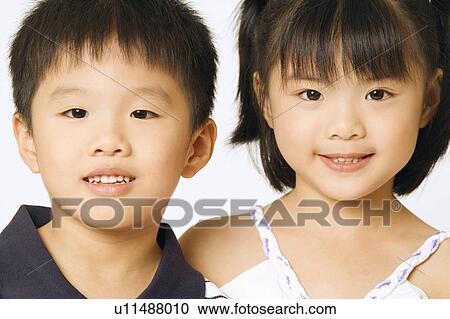 Stock Image - Portrait of a girl and her brother. Fotosearch