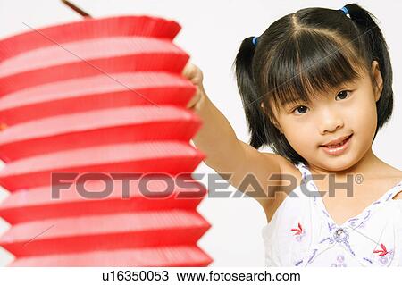 Portrait of a girl holding a Chinese lantern View Large Photo Image Stock Image - Portrait of a girl holding a Chinese lantern. Fotosearch