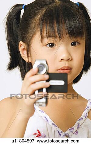 Portrait of a girl holding a home video camera View Large Photo Image Stock Photo - Portrait of a girl holding a home video camera. Fotosearch