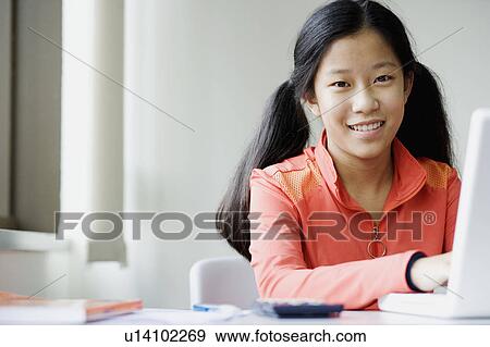 Portrait of a girl using a laptop View Large Photo Image Stock Photo - Portrait of a girl using a laptop. Fotosearch