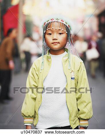 Stock Photo - Portrait of a girl wearing an ornate headdress. Fotosearch