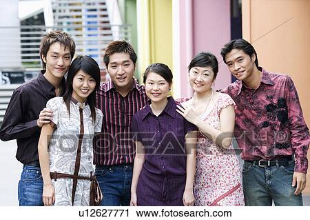 Stock Image - Portrait of a group of people standing together and smiling. Fotosearch