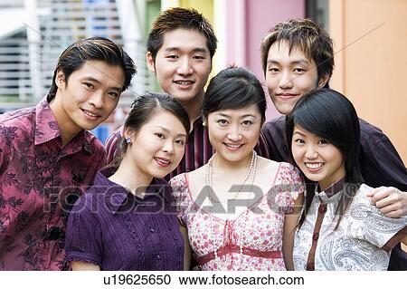Portrait of a group of people standing together and smiling View Large Photo Image Stock Image - Portrait of a group of people standing together and smiling. Fotosearch