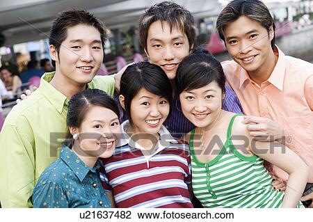 Portrait of a group of people standing together and smiling View Large Photo Image Stock Image - Portrait of a group of people standing together and smiling. Fotosearch
