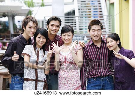 Stock Image - Portrait of a group of people standing together and smiling. Fotosearch