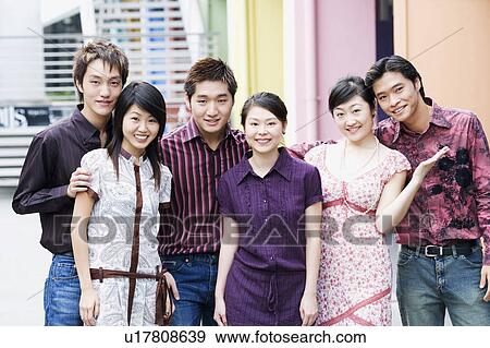 Stock Photo - Portrait of a group of people standing together and smiling. Fotosearch