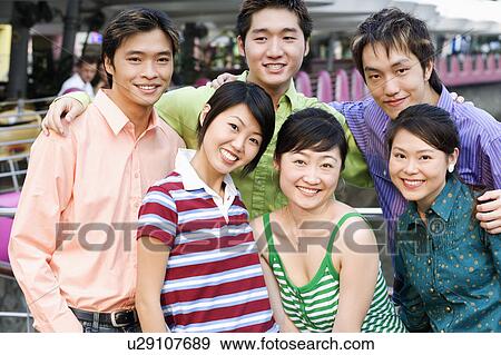 Portrait of a group of people standing together and smiling View Large Photo Image Stock Photo - Portrait of a group of people standing together and smiling. Fotosearch