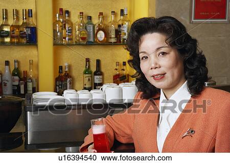 Portrait of a mature woman holding a glass View Large Photo Image Stock Image - Portrait of a mature woman holding a glass. Fotosearch