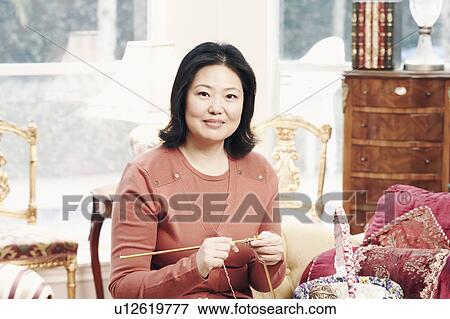 Portrait of a mature woman knitting View Large Photo Image Stock Photo - Portrait of a mature woman knitting. Fotosearch