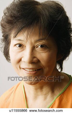 Portrait of a mature woman smiling View Large Photo Image Stock Photograph - Portrait of a mature woman smiling. Fotosearch