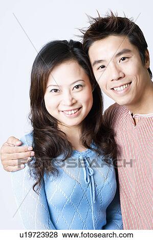 Stock Photo - Portrait of a mid adult man and a young woman smiling. Fotosearch