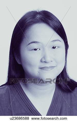 Stock Photo - Portrait of a mid adult woman smiling. Fotosearch
