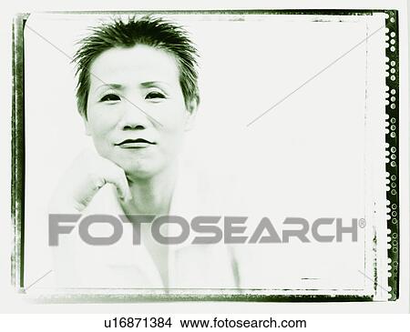 Portrait of a mid adult woman with her hand on her chin View Large Photo Image Picture - Portrait of a mid adult woman with her hand on her chin. Fotosearch