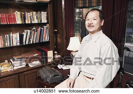 Portrait of a senior man sitting in an office View Large Photo Image Stock Image - Portrait of a senior man sitting in an office. Fotosearch