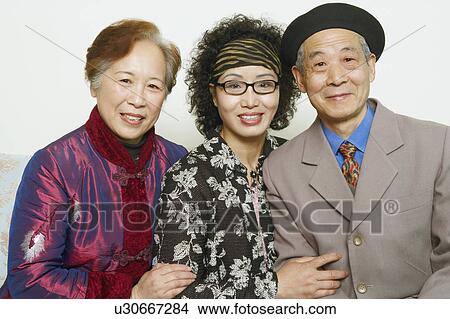 Portrait of a senior man sitting on a couch with two mature women View Large Photo Image Picture - Portrait of a senior man sitting on a couch with two mature women. Fotosearch