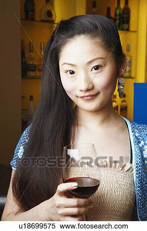Stock Photography - Portrait of a teenage girl holding a wineglass. Fotosearch