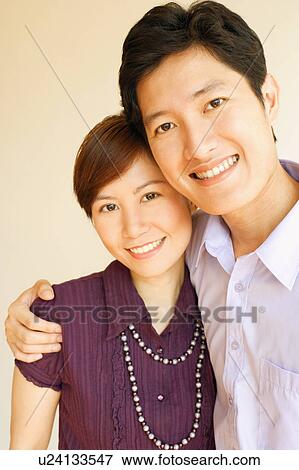 Portrait of a young couple smiling View Large Photo Image Stock Photo - Portrait of a young couple smiling. Fotosearch