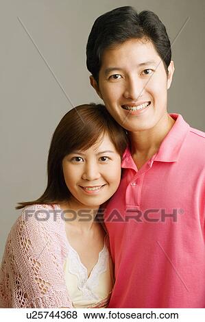 Portrait of a young couple smiling View Large Photo Image Stock Photo - Portrait of a young couple smiling. Fotosearch