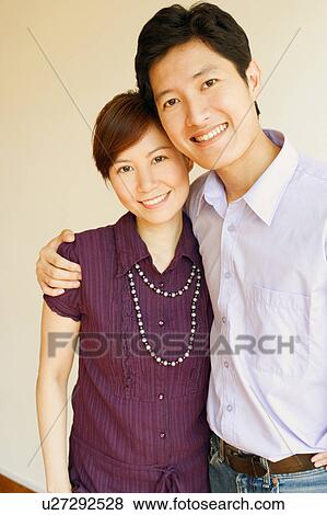 Portrait of a young couple smiling View Large Photo Image Stock Photo - Portrait of a young couple smiling. Fotosearch