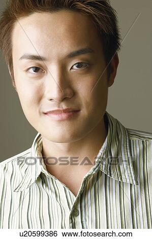 Stock Photograph - Portrait of a young man posing. Fotosearch