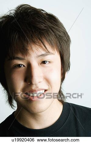 Stock Photograph - Portrait of a young man smiling. Fotosearch