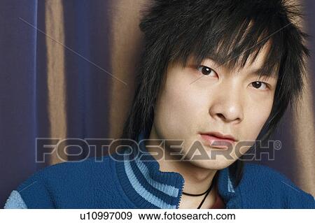 Stock Photo - Portrait of a young man thinking. Fotosearch