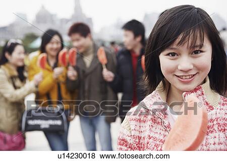 Portrait of a young woman holding a watermelon View Large Photo Image Stock Photo - Portrait of a young woman holding a watermelon. Fotosearch