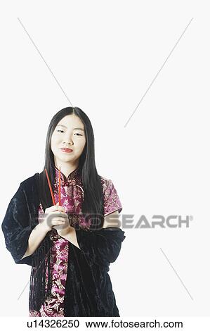 Portrait of a young woman holding chopsticks View Large Photo Image Stock Image - Portrait of a young woman holding chopsticks. Fotosearch